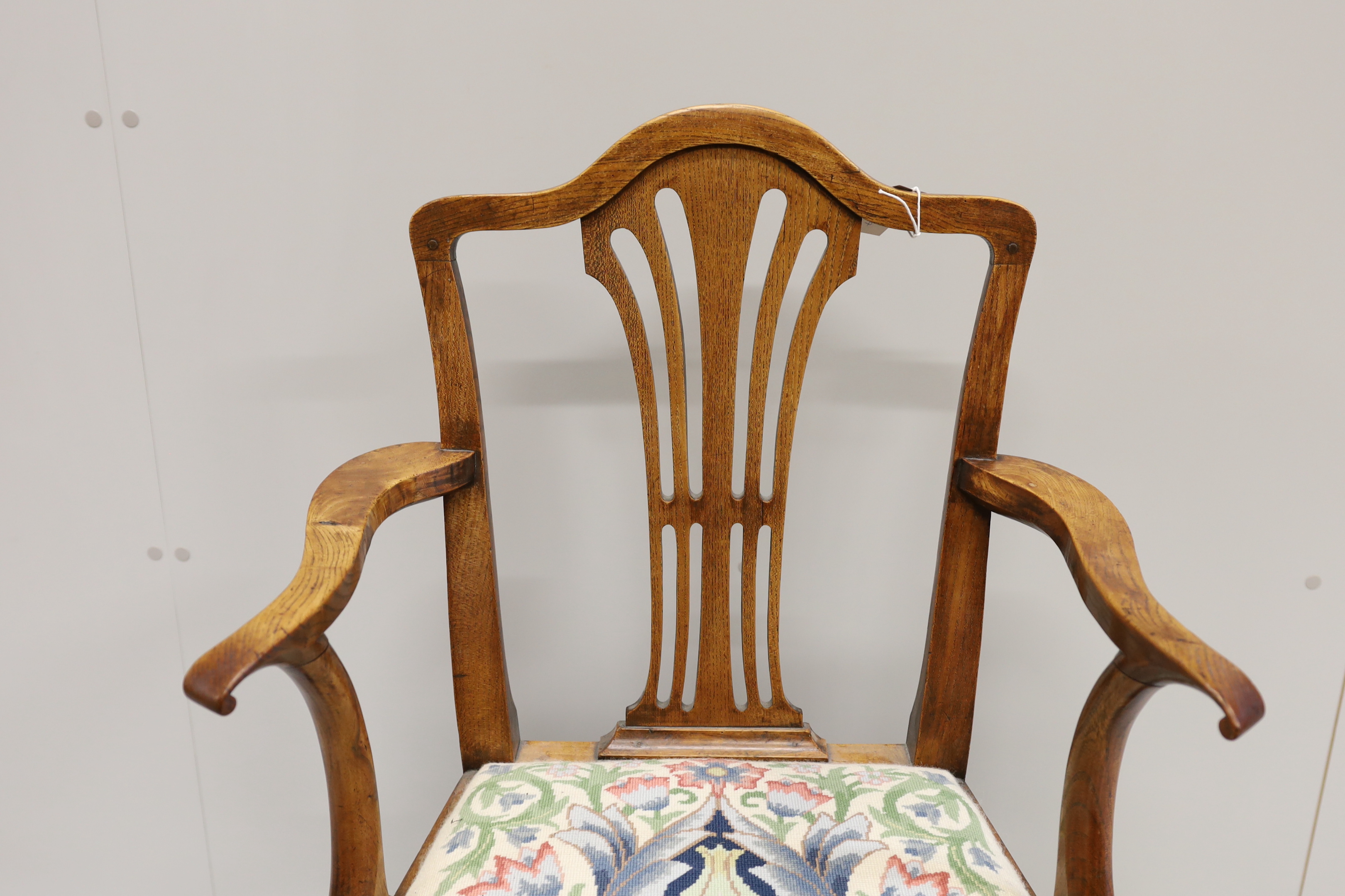 A George III provincial elm elbow chair, width 58cm, depth 45cm, height 94cm